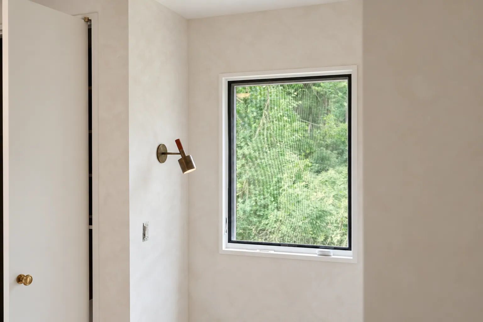 Limewash wall with a window onto the garden, Hamptons residence